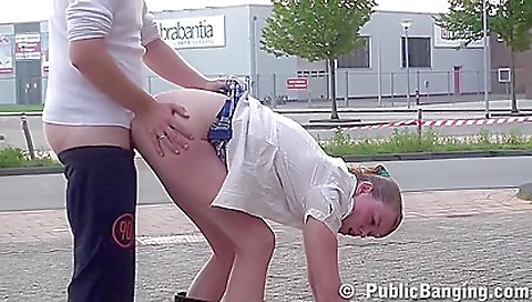 Brunette in red dress and white stockings in a park