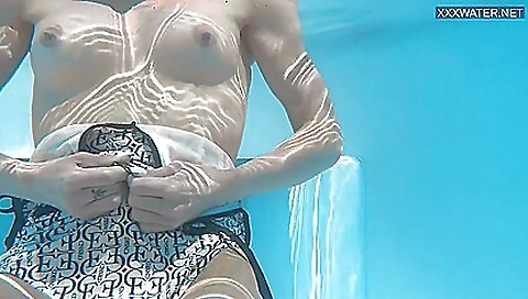 Gorgeous blonde in a sexy swimsuit naked in the pool