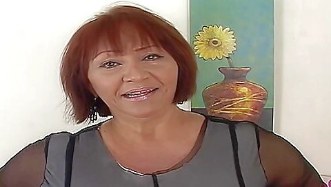 Mature brunette with big tits masturbates on the couch